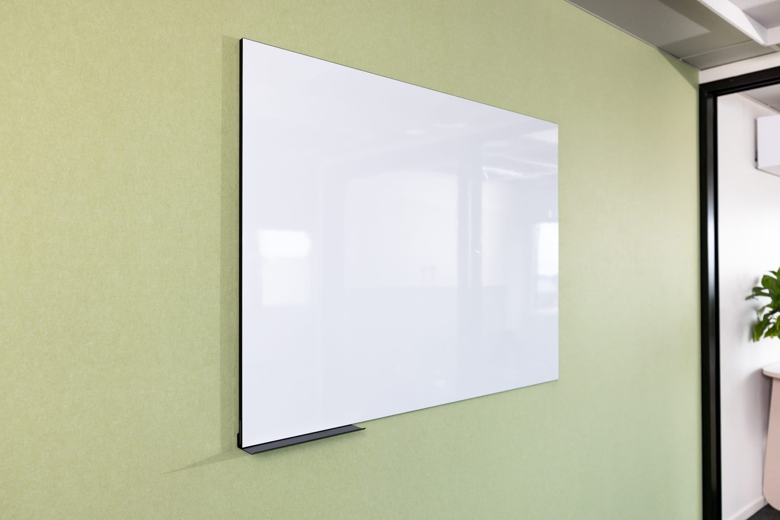 Era whiteboard mounted on a green felt wall in a meeting room